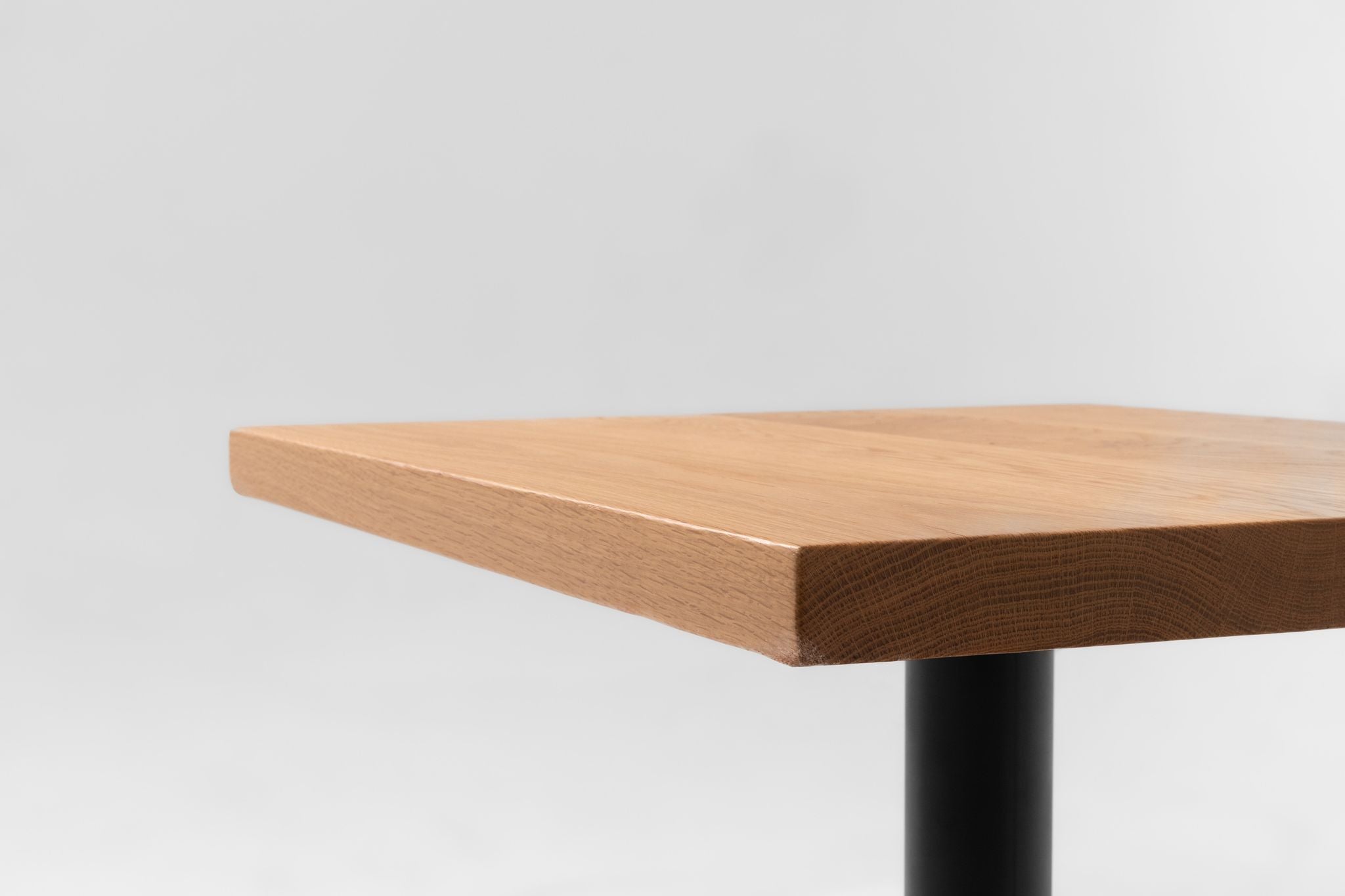 White oak table top edge with chamfered profile and black support