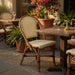 Woven side chair with beige seat and back, dark dot pattern, tan wood legs