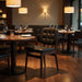 Sutton side chair with dark button-tufted leather-look upholstery and dark wood legs