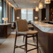Bar stool with tan upholstered seat and back, dark brown wood frame and footrest