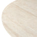 Close-up of round faux travertine dining table top, light beige stone-like texture