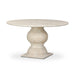 Round dining table with light beige faux travertine top and sculpted pedestal base