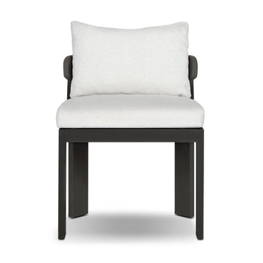 Light gray linen back cushion on black-framed outdoor dining chair with arm panels