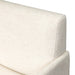 Close-up of off-white upholstered chair backrest fabric and curved arm support.
