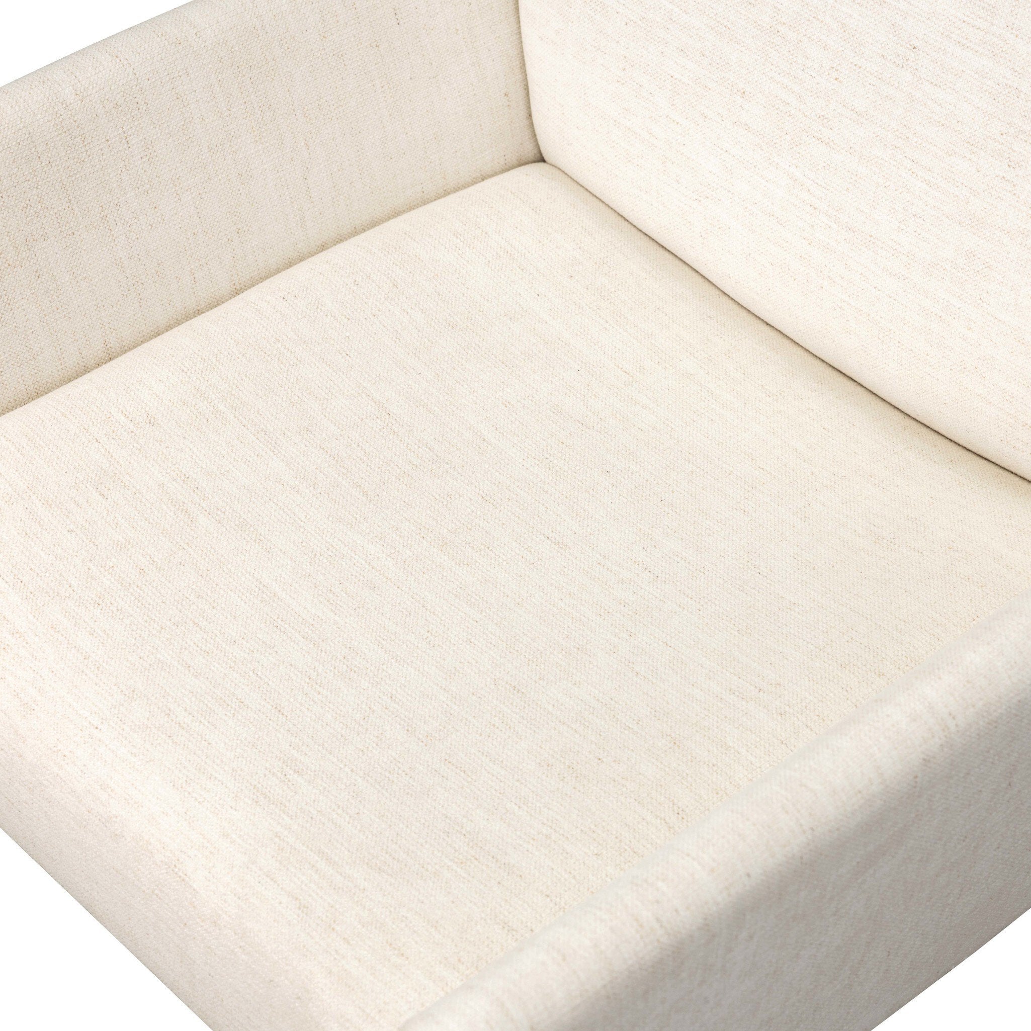 Close-up of off-white upholstered seat cushion and backrest junction.