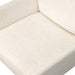Close-up of off-white upholstered seat cushion and backrest junction.