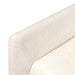 Close-up of off-white upholstered chair armrest with textured fabric surface.