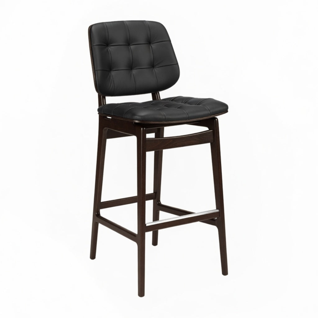 Tufted bar stool with black tufted seat, dark wood frame, and lower footrest