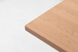 Maple table top corner close-up with straight edge and natural wood grain