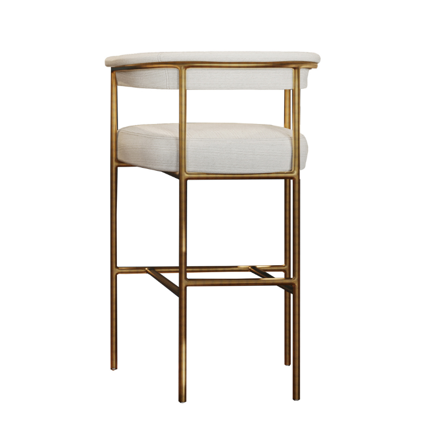 Upholstered bar stool with light fabric seat and back, gold-tone metal frame and base.