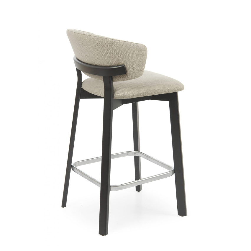 Taupe upholstered bar stool with black legs and chrome footrest