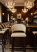 Rattan bar stool with round back, light woven seat, and dark wood frame