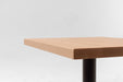 Maple table top corner with smooth squared edge and visible wood grain
