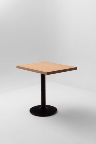 Square maple table top with straight edges on a black round pedestal base