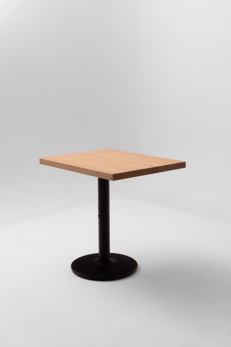 Square maple table top with straight edges on a black round pedestal base