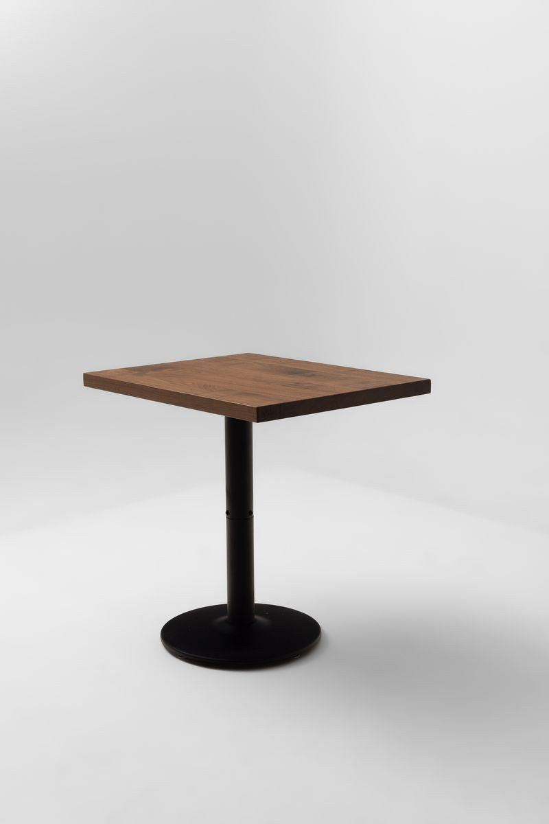 Square walnut tabletop with smooth top surface and dark pedestal base