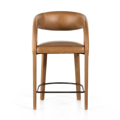 A butterscotch top-grain leather counter stool with a curved backrest and seat, featuring a black metal base.