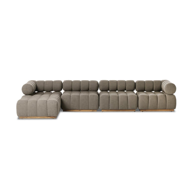 A modern four-piece outdoor sectional sofa with a teak wood base and tufted upholstery in a neutral color.