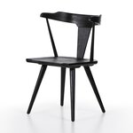 Black wooden chair on a white background. Ripley Dining Chair in Black Oak with mid-century Windsor-style sculptural silhouette.