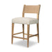Side view of cream counter stool with tan leather-look back and wooden legs
