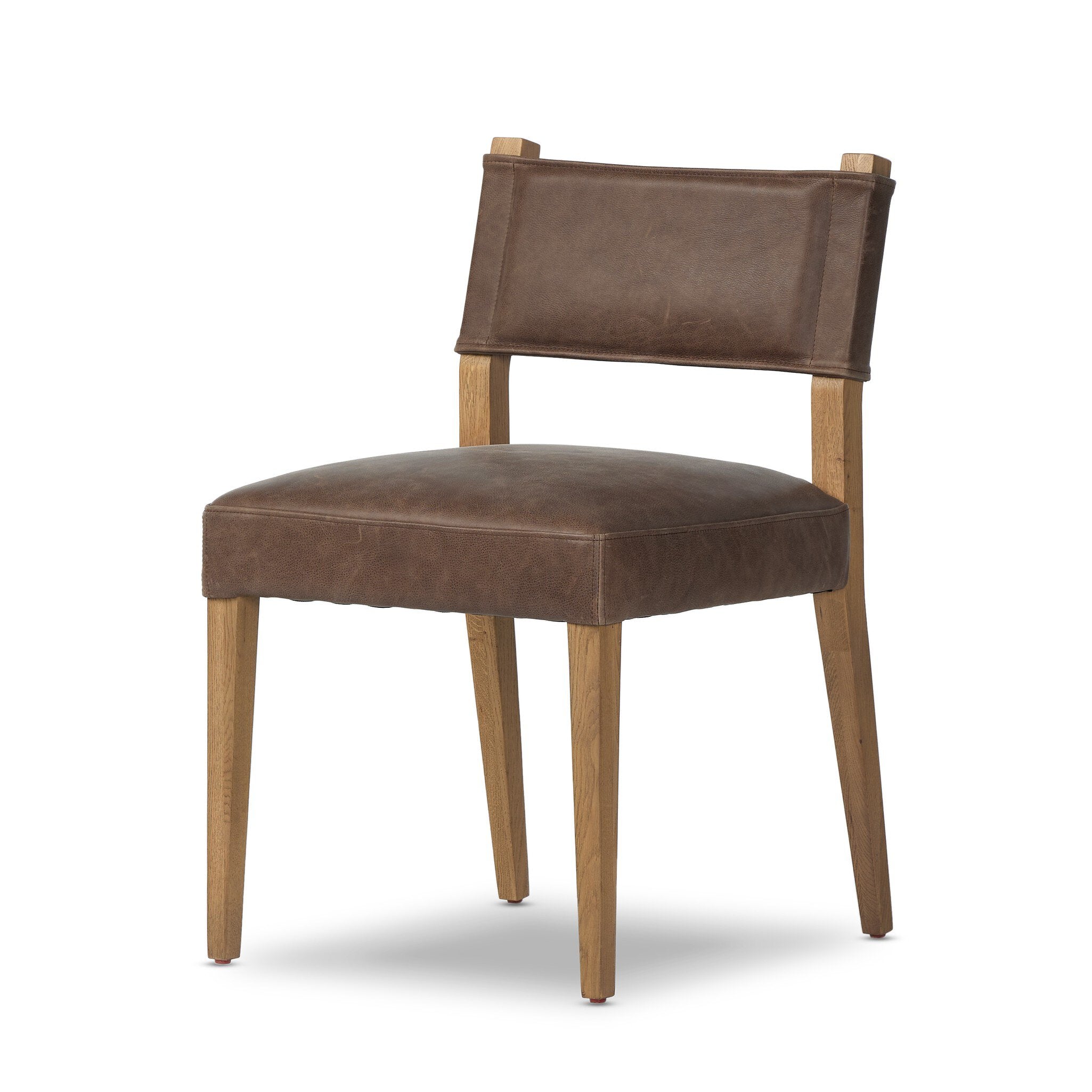 Brown armless dining chair angled view with upholstered seat and back, wood legs.