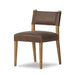 Brown armless dining chair angled view with upholstered seat and back, wood legs.
