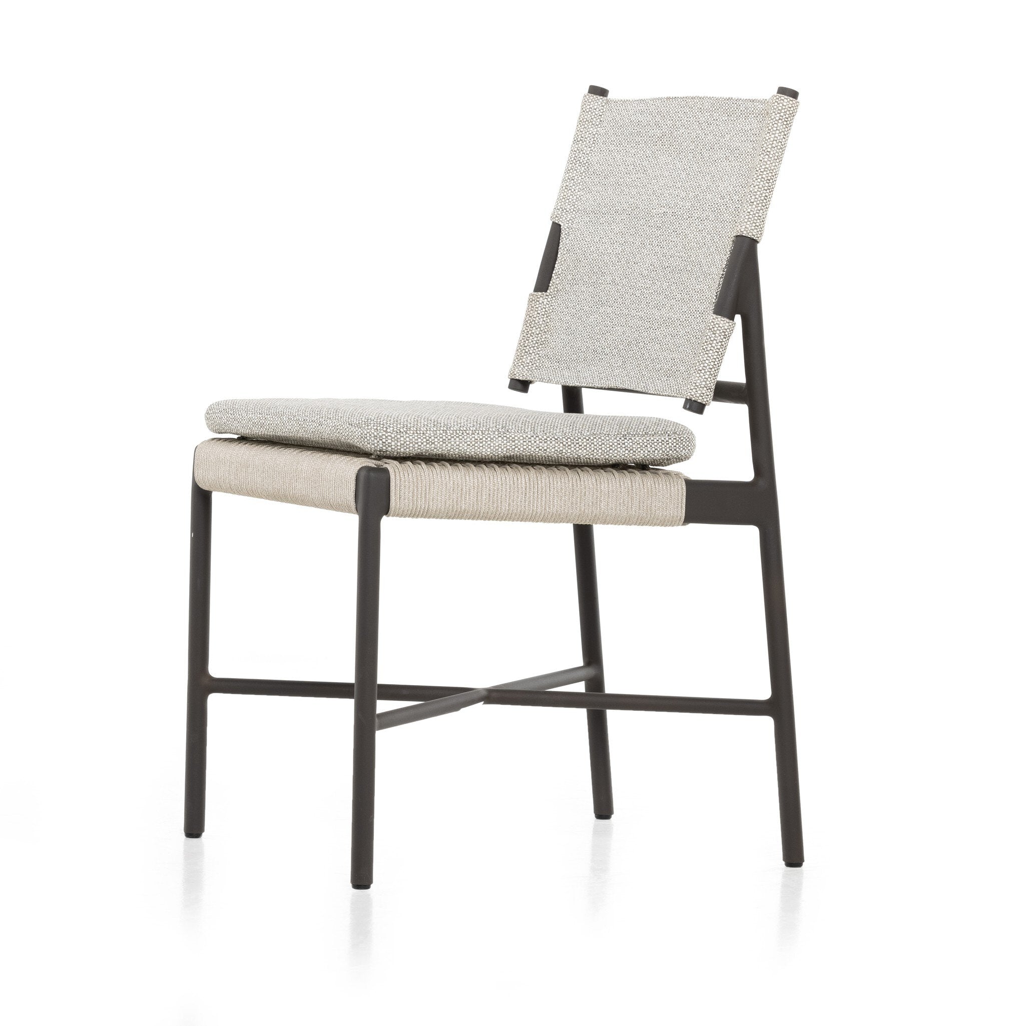 Angled Miller outdoor performance dining chair with a light taupe fabric cushion, wrap detail, and a crossed bronze aluminum frame.