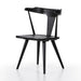 Black wooden chair on a white background. Angled Ripley Dining Chair in Black Oak with mid-century Windsor-style sculptural silhouette.