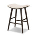 Natural linen counter stool with curved cushioned seat and dark wood crossbars