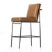 Crete bar stool from side angle with tan cushioned seat and back, black legs