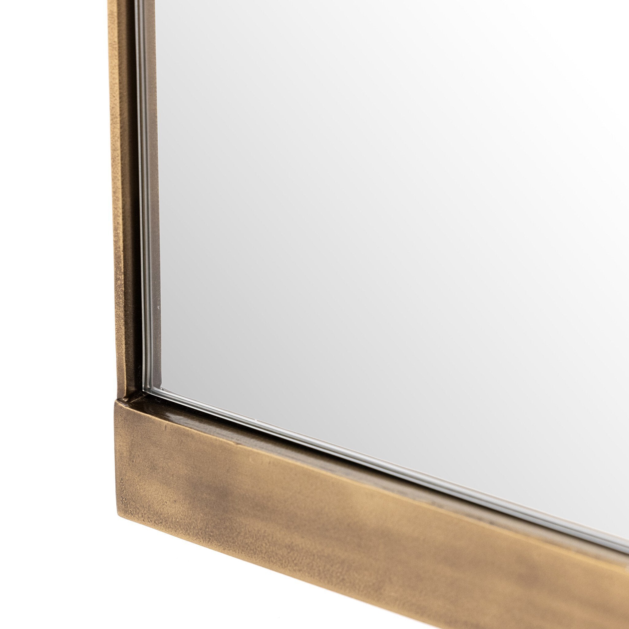 Angled bottom corner Chico small square wall mirror with a vertical antique brass suspension bar