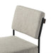 Gray upholstered chair with a black frame on a white background. Angled cushion view Benton Dining Chair in Savile Flannel performance fabric featuring a slim iron frame and wood bar.