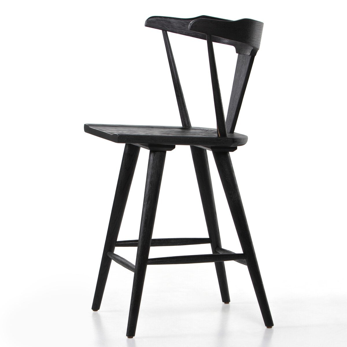Black oak counter stool side view with curved backrest, front rail, and footrest bar