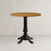Black cast table base with round wooden tabletop and ornate tripod legs