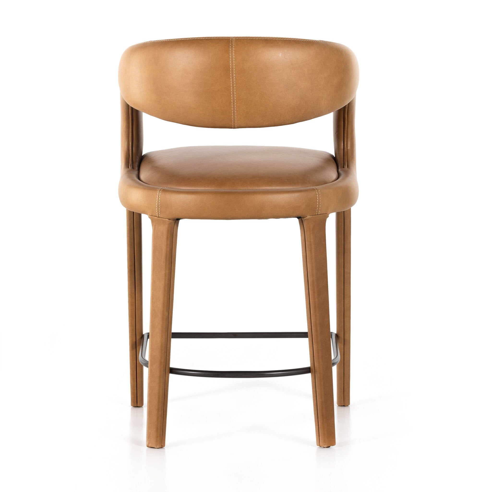 Counter stool front view with tan upholstered seat and back, curved arms, wood legs, black footrest.