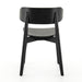 Black armless dining chair front view with curved backrest and round seat