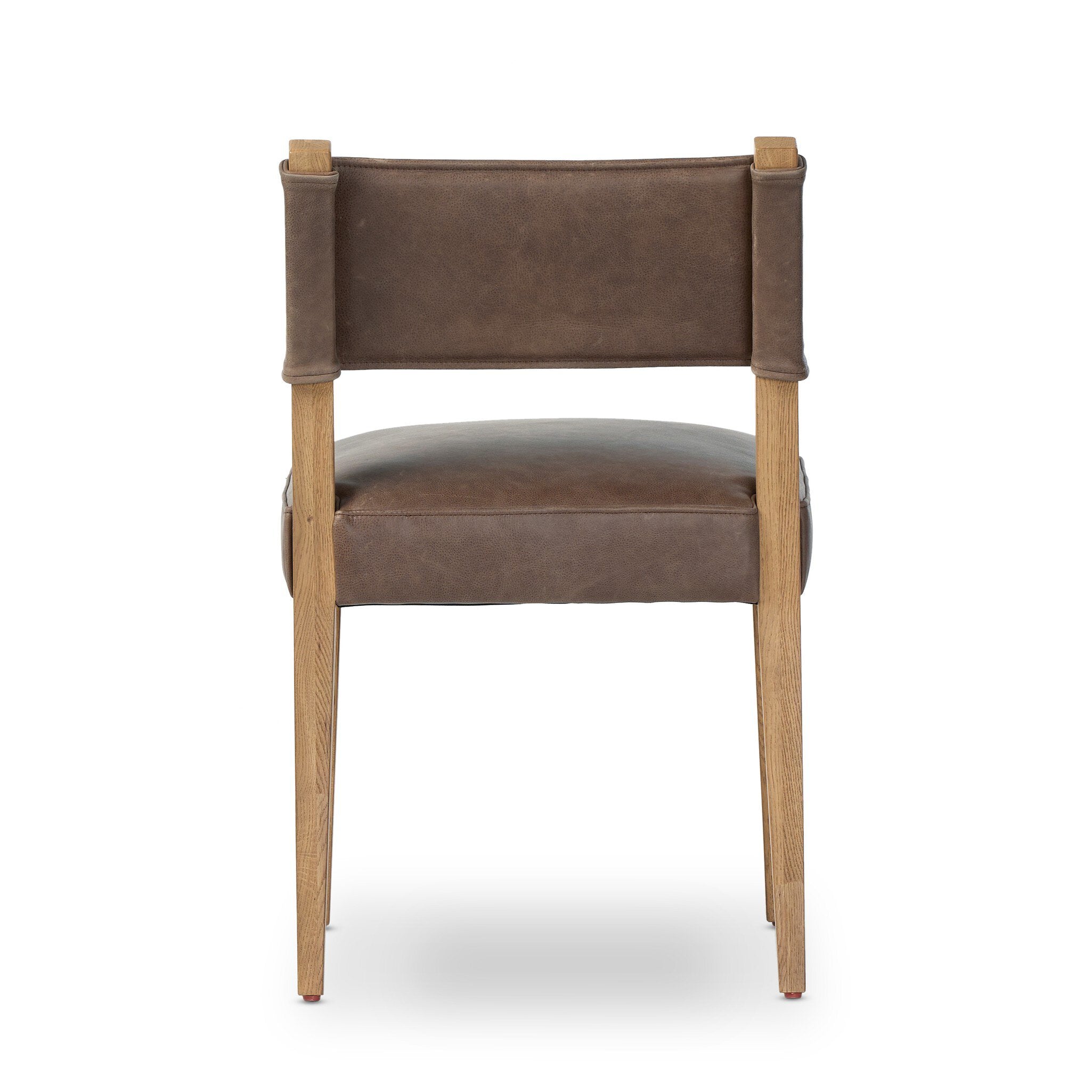 Brown armless dining chair front view with upholstered seat, back panel, and wood legs.