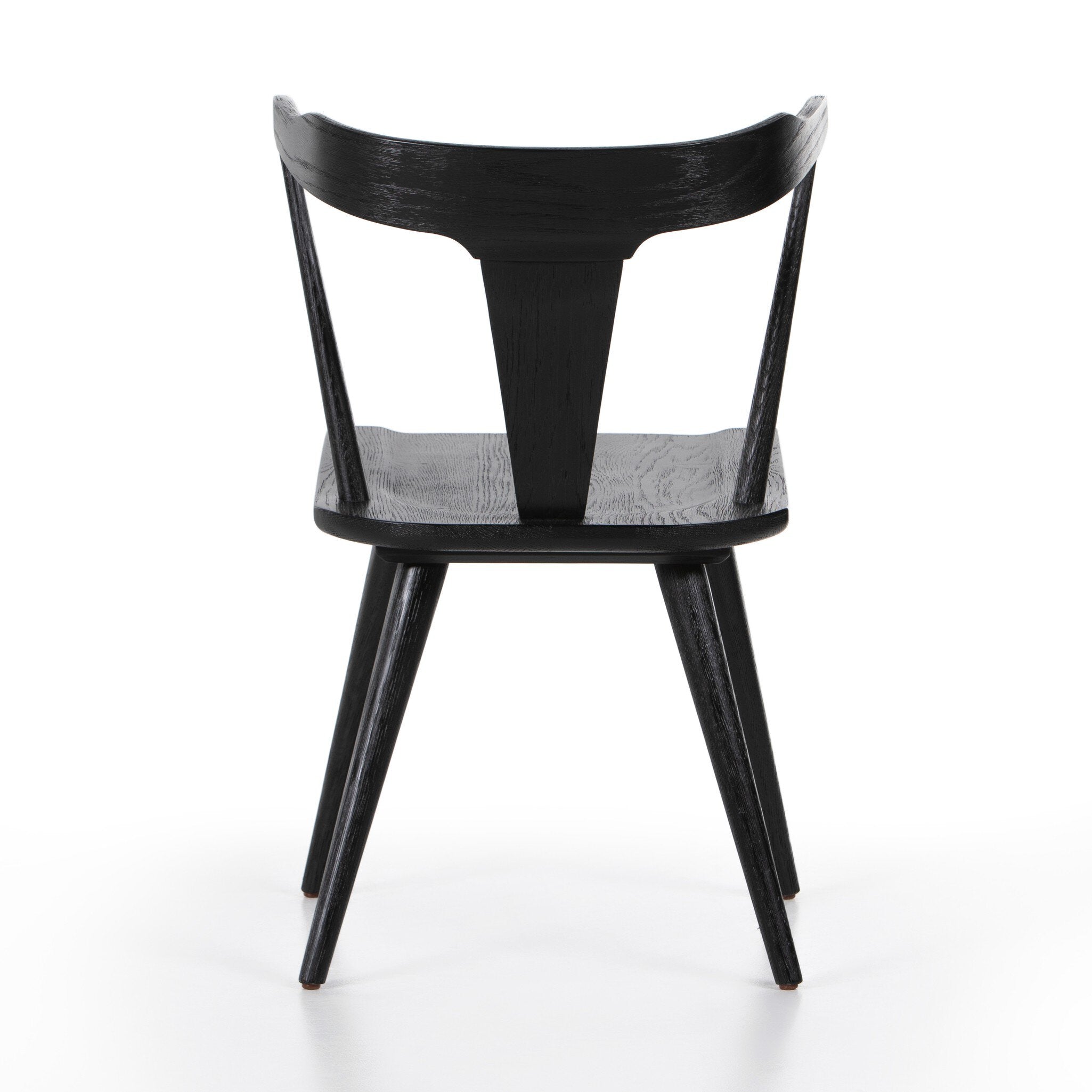 Black chair with a white background. Back view Ripley Dining Chair in Black Oak with mid-century Windsor-style sculptural silhouette.