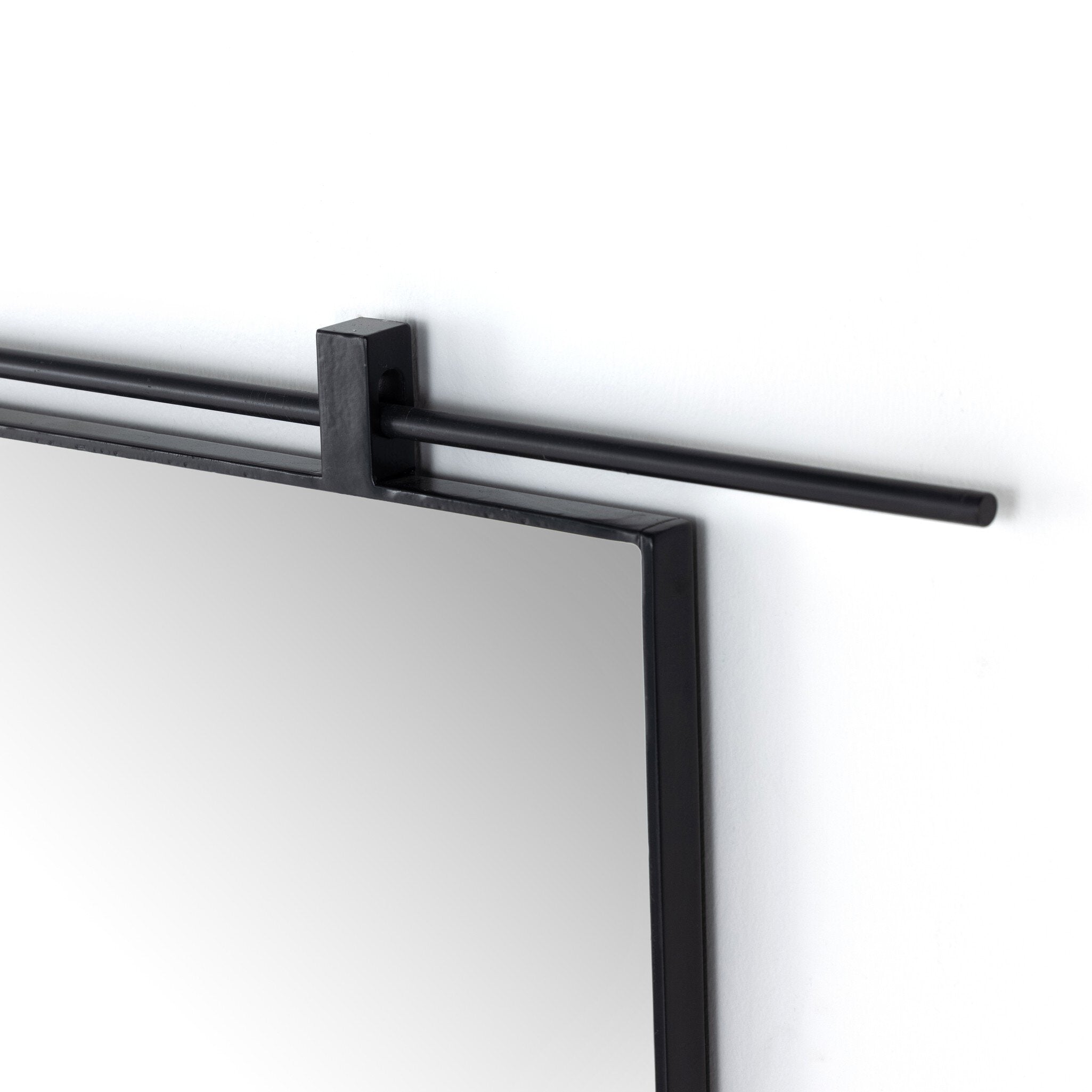 Black corner detail Chico 50-inch wide arch wall mirror with a vertical antiqued iron suspension bar