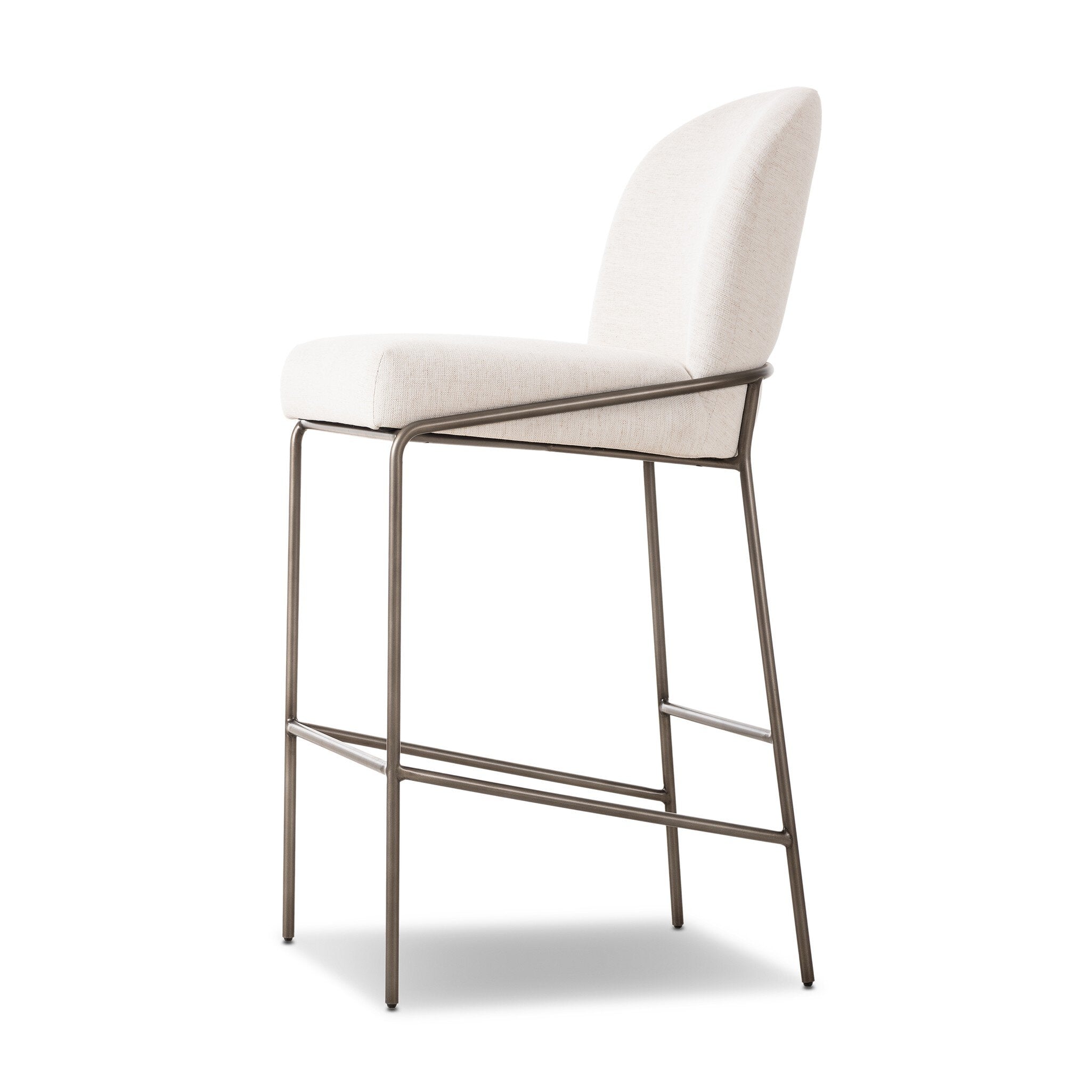 Light upholstered bar stool at three-quarter view; padded seat and backrest with metal footrest