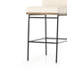 Bar stool with light cushion and black metal base, close front view of frame