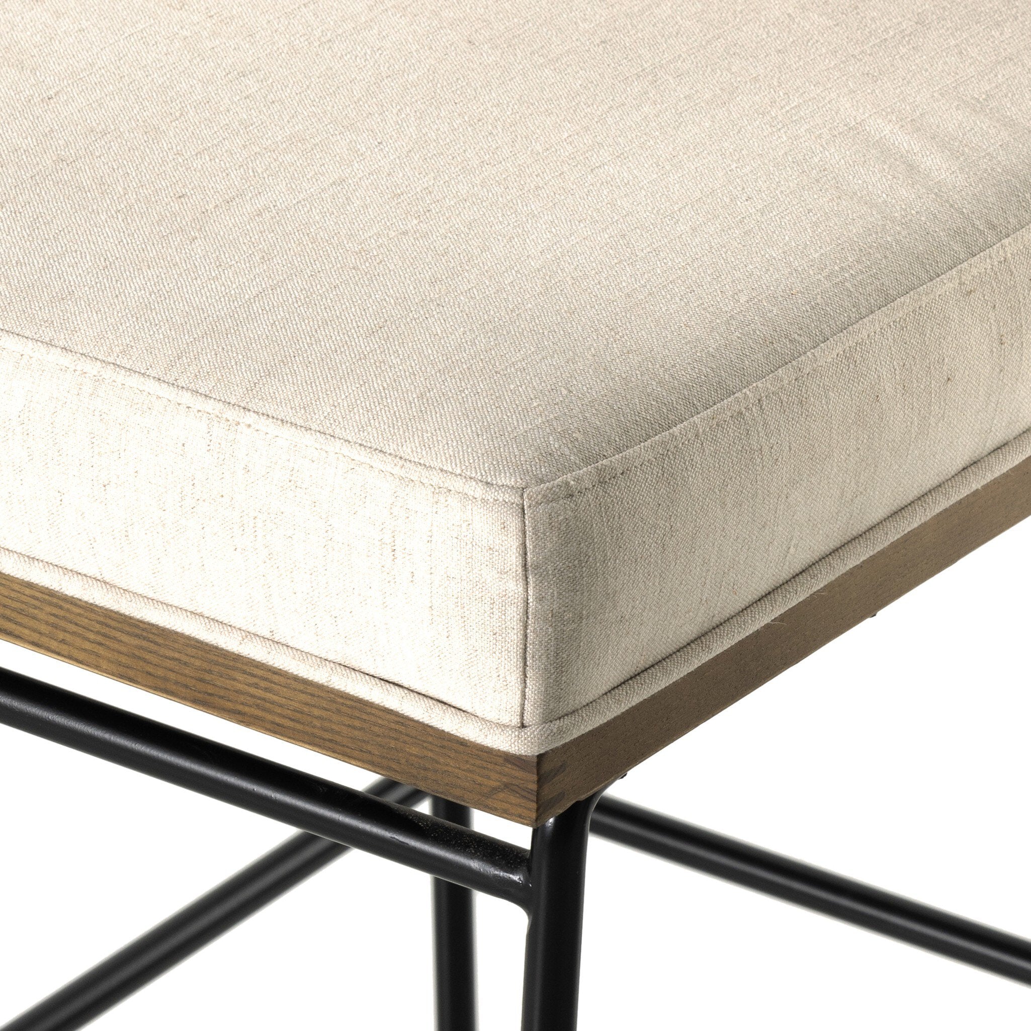 Bar stool cushion edge with light upholstery fabric and stitched seam detail