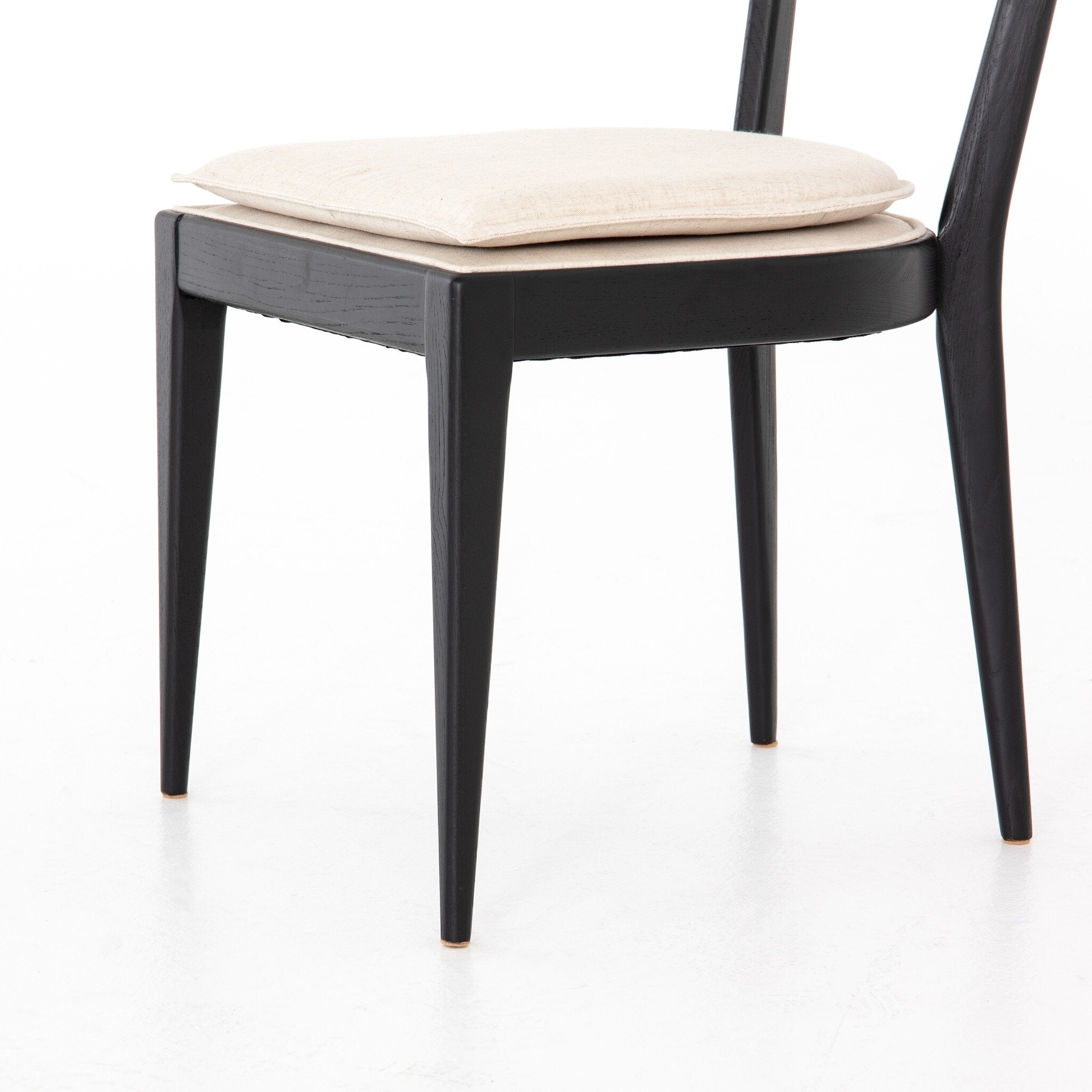Bottom legs detail Britt Dining Chair in Cambric Ivory performance fabric with black parawood tapered legs
