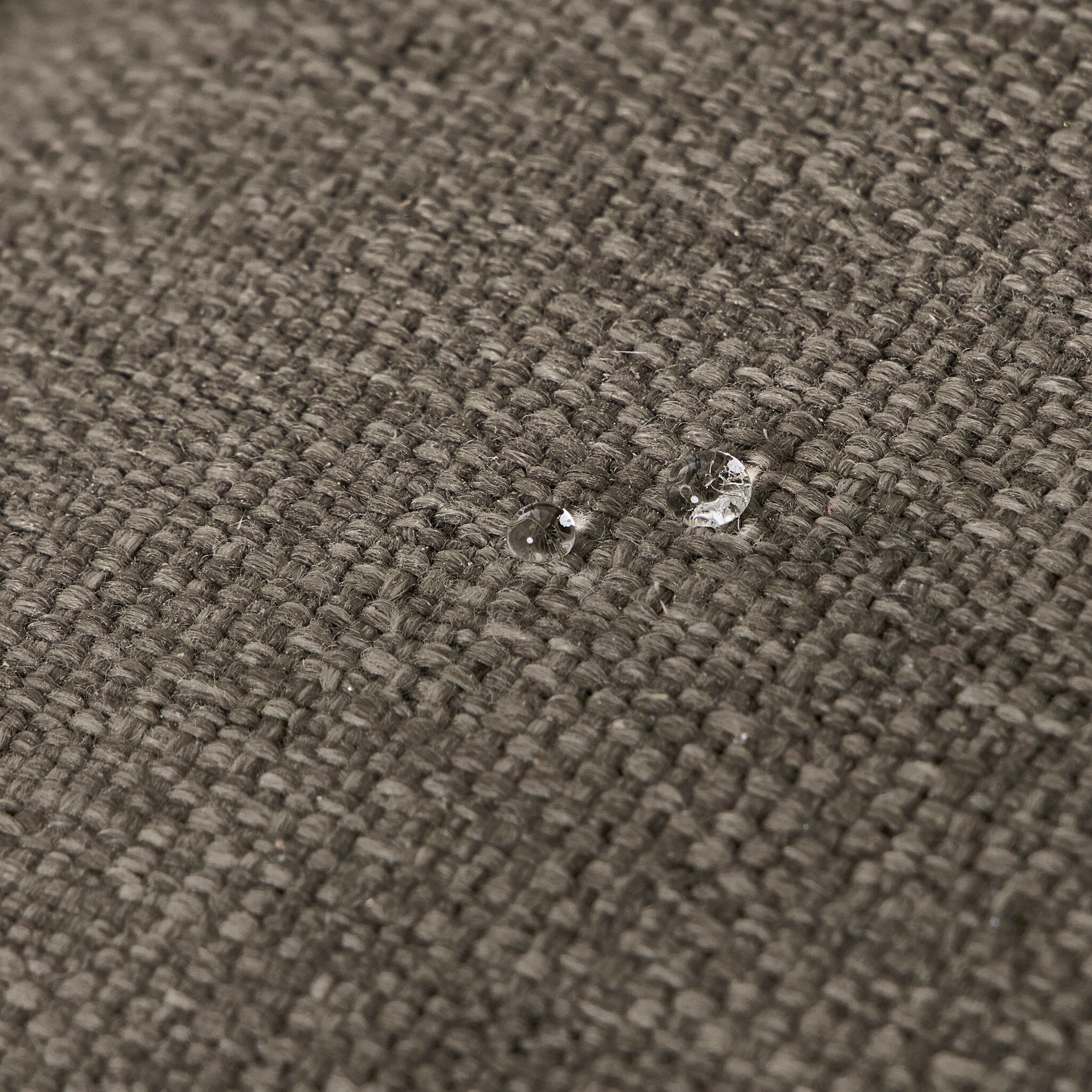 Outdoor sectional upholstery fabric close-up with tight weave and light specks