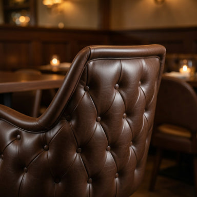 Dark brown tufted high-back bar stool backrest with button-tufting and curved arms