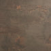 Close-up of concrete-style tabletop surface with mottled dark gray and warm rust speckles.