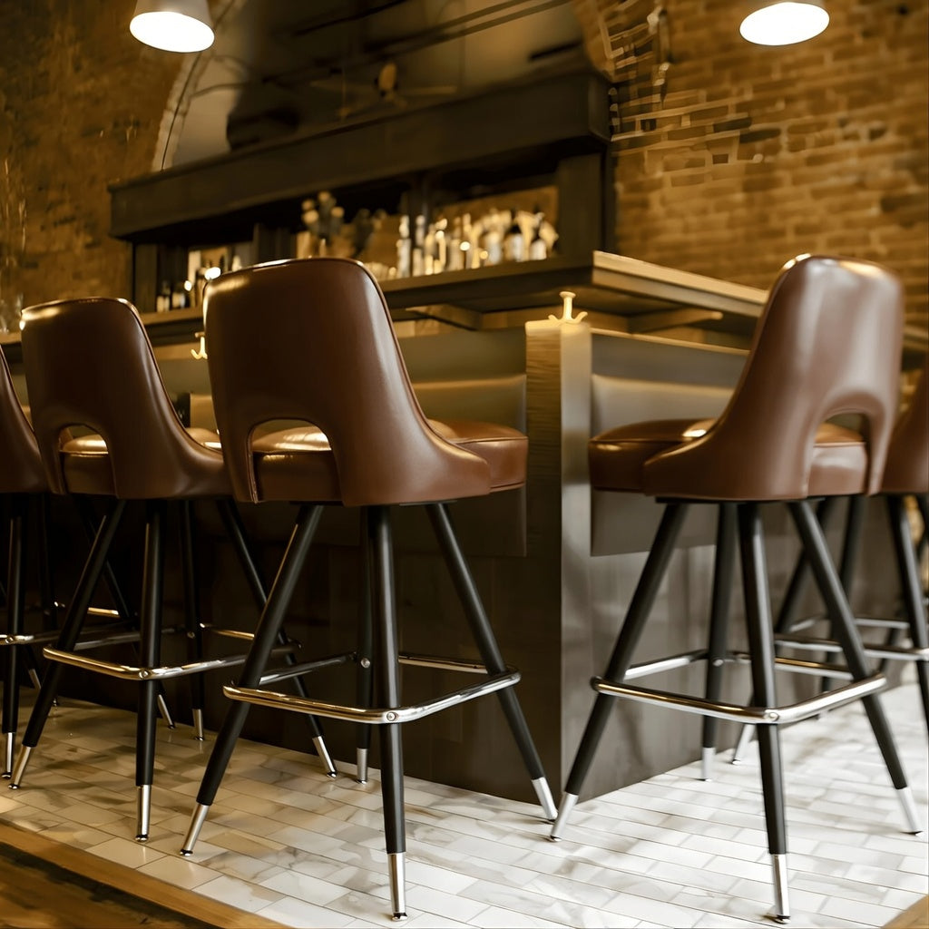 Celine modern bar stool featuring a sculptural cutout back and a softly cushioned upholstered seat with a minimalist metal frame in hospitality