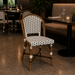 Woven side chair angled view, curved rattan back and white-black seat on dark legs