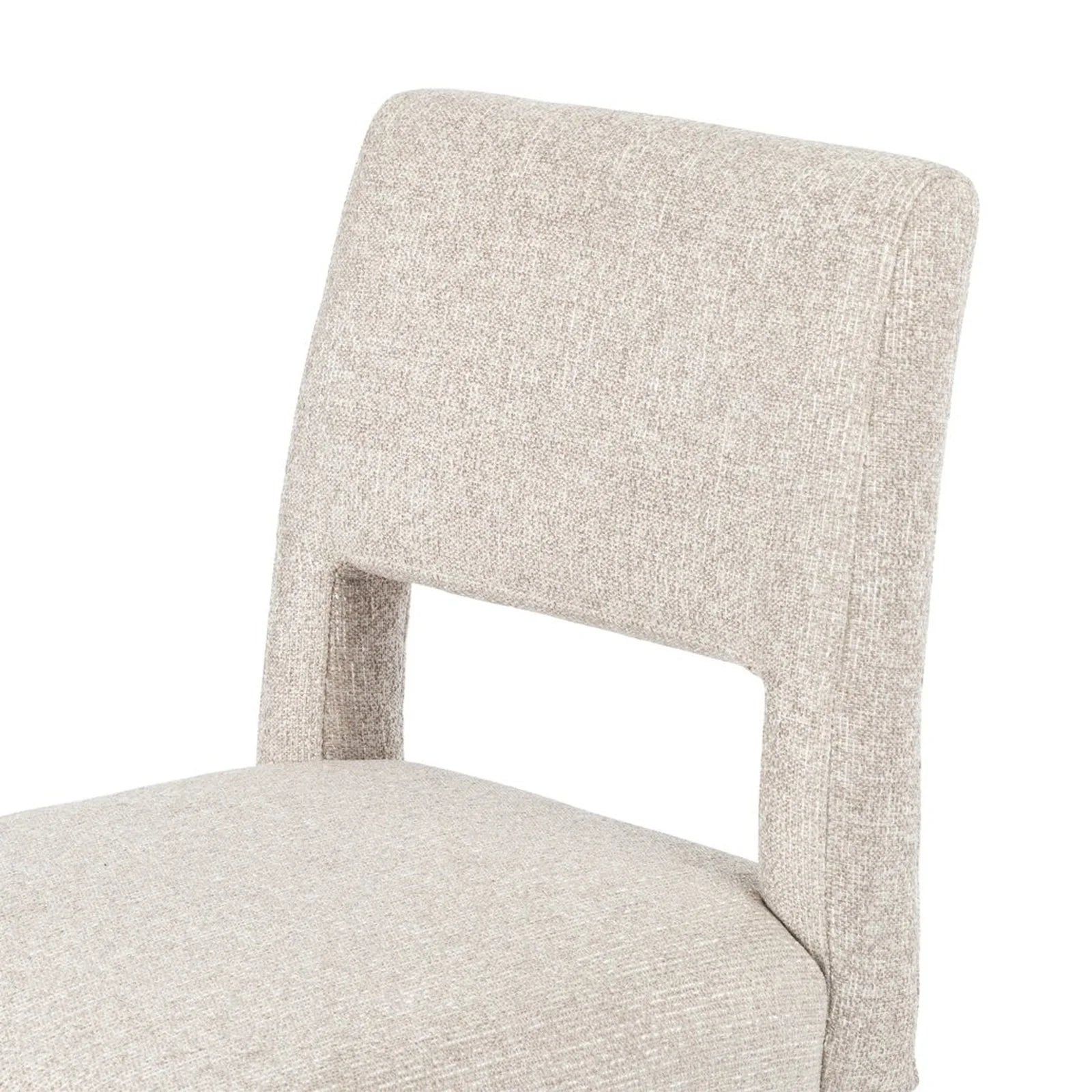 Armless dining chair with light camel textured upholstery, visible backrest and wooden legs.