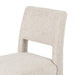 Armless dining chair with light camel textured upholstery, visible backrest and wooden legs.